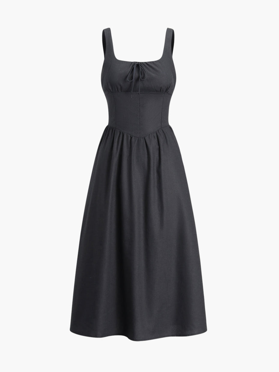 Zwarte jurk met getailleerde taille en strikdetail